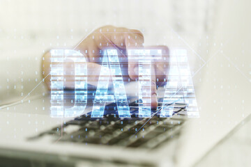 Wall Mural - creative data word hologram and hands typing on computer keyboard on background, big data and blockc