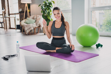 Sticker - Photo of strong charming young girl dressed sport suit recording video yoga lesson waving arm smiling indoors house home