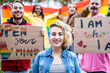 © MandriaPix - happy multiracial people from different generation celebration gay parade, portrait of a gender fluid young woman
