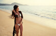 © luengo_ua - Vacation on the seashore.Young beautiful woman  with long brunette hair on the sand beach.