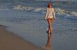 woman walking on the beach in white mesh top and white thong panties