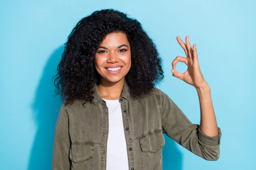 Sticker - Photo of youth african lady show fingers okey symbol ad choose recommend approve isolated over blue color background