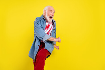 Sticker - Portrait of attractive cheerful carefree grey-haired man dancing fooling having fun isolated over shine yellow color background