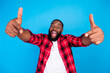 © deagreez - Photo of cool millennial brunet guy point wear plaid shirt isolated on blue color background