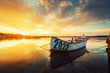 2022 Concept Fishing Boat On Varna Lake With A Reflection In The Water At Sunset.