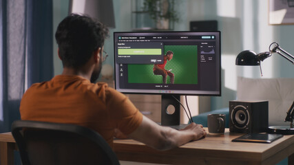 Anonymous male using computer to integrate 3D graphic into footage with real man during work in home office