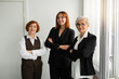 © Alexandr - three adult successful women in suits in offices