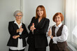 © Alexandr - three beautiful adult women in suits with hand gesture