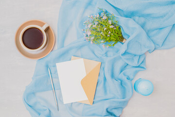 Wall Mural - workspace wedding invitation with a scarf, blue flowers on a light background