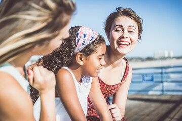 Wall Mural - happy gay couple spending time together with their adopted daughter