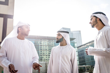 Wall Mural - Three arabic business men spending time in Dubai