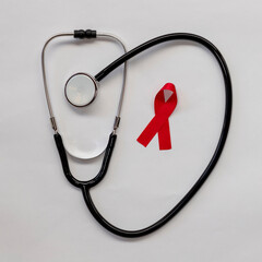 Wall Mural - stethoscope and red ribbon. AIDS prevention campaign. red december