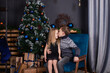 © OliaVesna - happy kids playing with christmas presents. brother and sister near christmas tree giving new year gifts to each other. family time. siblings love
