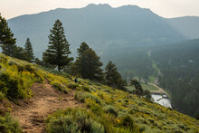 Woman Looks Out Over Estes Park From Hillside Trail