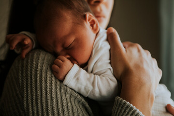 Wall Mural - mother holding her baby indoors