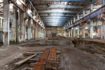 Canvas Print - a huge room of an abandoned factory, an empty hangar with iron floors