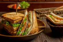 Homemade Club Sandwich With Ham, Egg And Cheese,tomatoe, Lettuce,onion On Dark Background. Rustic Style. Selective Focus. Copy Space. No.10