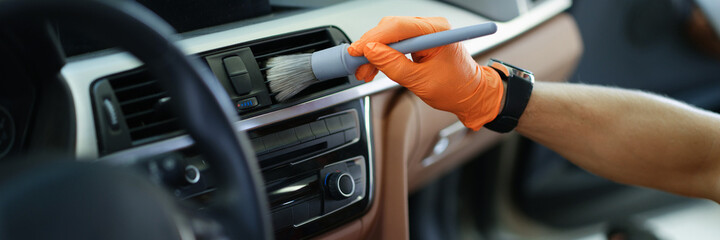 Wall Mural - Repairman in rubber gloves wiping dust from duct with brush closeup