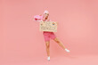 Full body happy fun young woman with bright dyed rose hair in rosy top shirt hat holding skateboard card sign be yourslef title test isolated on plain light pastel pink background studio portrait