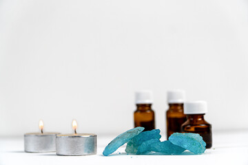 sea salt,candles and aromatic oils in bottles on a white background. Accessories for massage in the spa salon. The concept of cosmetic procedures.