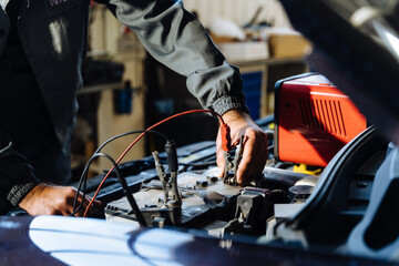 Car service, repair, maintenance concept. Close up of hands car electrician repairs car, tester and fuses and nippers.