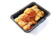 © mark_gusev - Raw corn fed chicken stuffed thighs wit herbs in a black plastic tray. The product has pronounced yellow color and special taste. Fresh poultry. Meat industry. Butcher craft and skill.