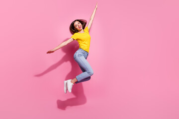 Wall Mural - photo of cute childish young lady dressed yellow clothes smiling arms sides jumping high isolated pi