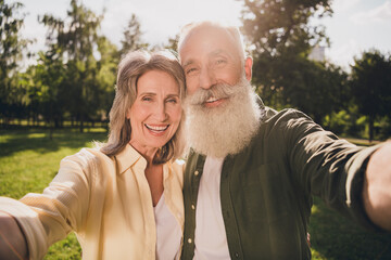 Canvas Print - Photo of wife husband happy old man woman make selfie smile weekend walk outdoors outside park in city forest