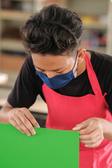 Young carpenters installing laminate for built-in  cabinets at the workshop