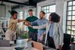 © bernardbodo - Group of colleagues joining their hands together in unity