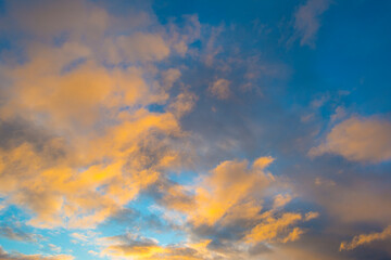 Wall Mural - Clouds in a blue sky in bright sunlight at sunrise in autumn, Almere, Flevoland, The Netherlands, November 29, 2021
