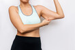 © Марина Демешко - Cropped shot of young caucasian woman grabbing skin on her upper arm with excess fat isolated on a white background. Overweight, excess weight. Pinching the loose and saggy muscles.Taking care of body