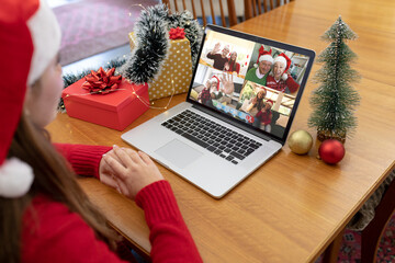 Sticker - Caucasian woman in santa hat making laptop christmas group video call with family and friends