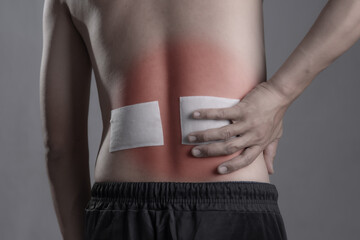 Medicated pain relief patch with man pain Lower Back,office syndrome,Health problems from overworked concept.