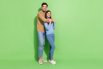 Canvas Print - Photo of two dreamy people peaceful guy cuddle cheerful lady wear casual outfit isolated green color background