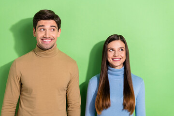 Canvas Print - Portrait of attractive lady handsome guy look interested empty space isolated on green color background