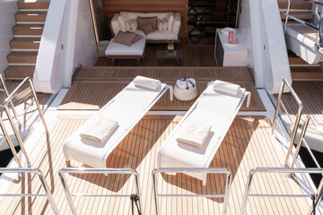Aft deck with two sunbeds, couch, table on luxury yacht sun terrace Monaco yacht show