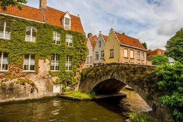 Wall Mural - Medieval stone bridge on canal, on canal, Bruges, West Flanders, Belgium.