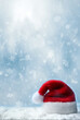 © Belight - Santa claus hat with snow and blue snowfall background