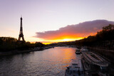 Fototapeta  - Eiffel tower in Paris at sundown: romantic and perfect for Valentine's day. Bateau mouche
