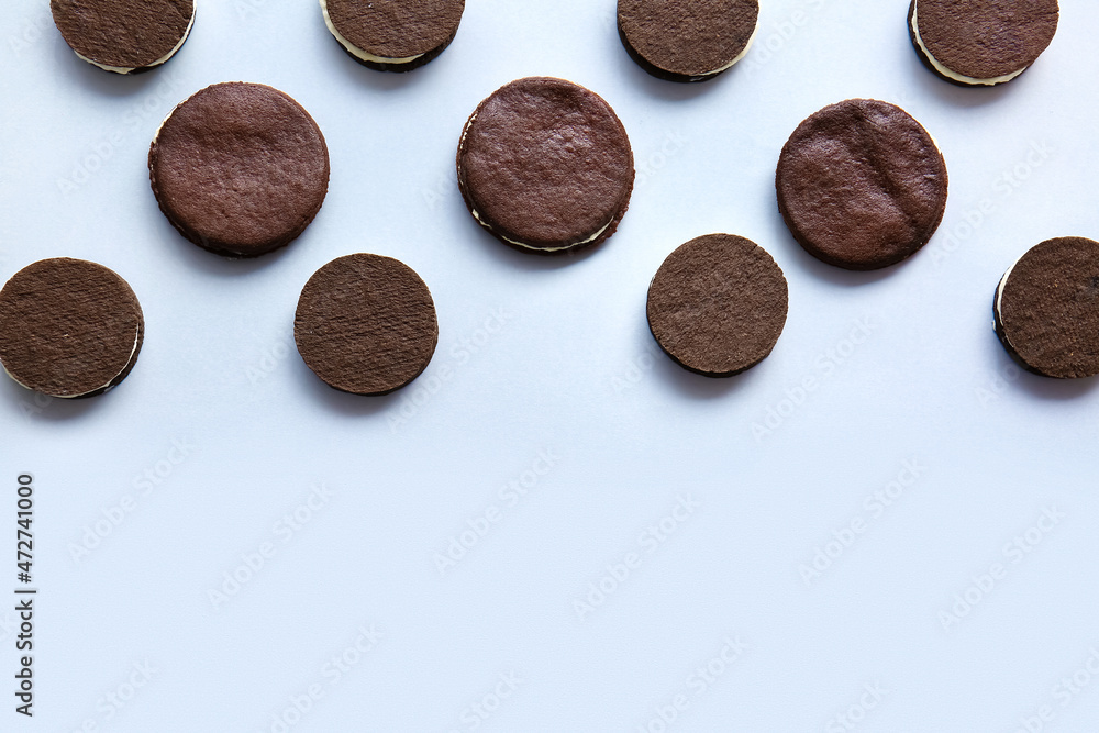 Tasty chocolate cookies with cream on white background