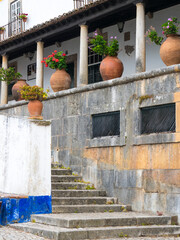 Poster - Portugal, Obidos. Ceramic pots adorning a building ledge.