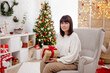 © Di Studio - Happy woman with present in christmas room