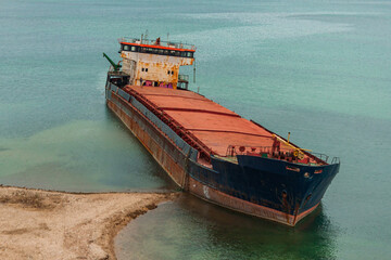 Shipwrecked in the Black Sea dry cargo ship Surov. Traces of oil products can be seen in the water. An abandoned ship at sea in Russia.