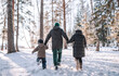 © avtk - Family walking in winter forest