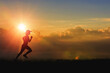 © jayzynism - Woman running alone at beautiful sunset in the valley. Summer sport and healthy concept.