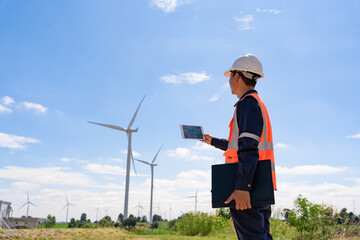 Wall Mural - Engineer walk to check wind power plants with check performance. Wind turbines are an alternative electricity source to be sustainable resources in the future. Clean energy concept saves the world