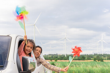 Wall Mural - Wind turbines are an alternative electricity source to be sustainable resources in the future. People in the community with wind generators turbines. Clean energy concept saves the world