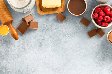 Poster - Ingredients for cooking raspberries and chocolate pie with copy space top view. Bakery background