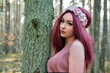 Female model in forest, daytime photo session. Young woman with red hairs, princess style.